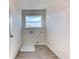 Laundry room with white flooring, window, and shelving at 16134 69Th Lane East, Parrish, FL 34219