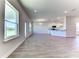Open concept living area with wood-look floors and lots of natural light at 16134 69Th Lane East, Parrish, FL 34219
