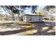 White single story home with covered carport and gazebo in backyard at 17130 Pasco Acres Dr, Spring Hill, FL 34610