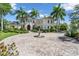 Elegant home with lush landscaping, paved circular driveway, and a stone fountain feature at 19451 Ganton Ave, Bradenton, FL 34202