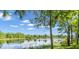 Scenic lake view with lush green trees and a clear sky at 19451 Ganton Ave, Bradenton, FL 34202