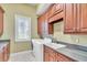 Bright laundry room with washer, dryer, and ample cabinetry at 19451 Ganton Ave, Bradenton, FL 34202