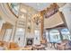 Two-story living room with a large fireplace and lots of natural light at 19451 Ganton Ave, Bradenton, FL 34202