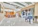 Spacious living area with a piano and access to the kitchen and pool at 19451 Ganton Ave, Bradenton, FL 34202