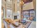 Elegant living room boasts a fireplace, high ceilings, and large windows overlooking the pool at 19451 Ganton Ave, Bradenton, FL 34202