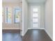 Bright entryway with white door, dark hardwood floors, and view into living area at 707 W Fribley St, Tampa, FL 33603