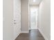 Clean hallway with hardwood floors and access to bathroom and bedrooms at 707 W Fribley St, Tampa, FL 33603