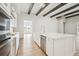 White kitchen with stainless steel appliances and large island with quartz countertops at 11618 Gleaming Ter, Venice, FL 34293