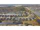 Aerial view of houses surrounding a lake in a neighborhood at 6843 Boulder Run Loop, Wesley Chapel, FL 33545