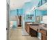 Double vanity bathroom with light blue walls and walk-in shower at 6843 Boulder Run Loop, Wesley Chapel, FL 33545