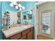 Bathroom with light teal walls and sink at 6843 Boulder Run Loop, Wesley Chapel, FL 33545