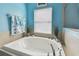 Soaking tub in a bathroom featuring light blue walls and natural light at 6843 Boulder Run Loop, Wesley Chapel, FL 33545