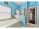 Relaxing bathroom with soaking tub and walk-in closet at 6843 Boulder Run Loop, Wesley Chapel, FL 33545