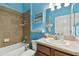 Bathroom with a tub, single vanity, and light blue walls at 6843 Boulder Run Loop, Wesley Chapel, FL 33545
