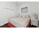 Bedroom with a large bed, hardwood floors, and ocean themed decor at 6843 Boulder Run Loop, Wesley Chapel, FL 33545