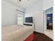 Bedroom with a large bed, hardwood floors, and ocean themed decor at 6843 Boulder Run Loop, Wesley Chapel, FL 33545