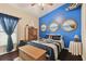 Nautical themed bedroom with a full bed and blue walls at 6843 Boulder Run Loop, Wesley Chapel, FL 33545