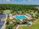 Community pool with plenty of lounge chairs and a playground nearby at 6843 Boulder Run Loop, Wesley Chapel, FL 33545