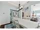 Elegant dining room with white furniture and a view of the living area at 6843 Boulder Run Loop, Wesley Chapel, FL 33545