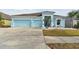 House exterior showcasing a light blue color scheme and landscaping at 6843 Boulder Run Loop, Wesley Chapel, FL 33545