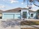 Charming two-story home with light blue exterior and landscaping at 6843 Boulder Run Loop, Wesley Chapel, FL 33545