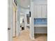 Hallway with tile floors, built-in desk, and access to bedrooms and bath at 6843 Boulder Run Loop, Wesley Chapel, FL 33545