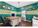 Home office with wood floors, two desks, and green walls at 6843 Boulder Run Loop, Wesley Chapel, FL 33545