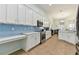 Modern kitchen with stainless steel appliances and white cabinets at 6843 Boulder Run Loop, Wesley Chapel, FL 33545