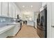 Bright kitchen with white cabinets, granite counters, and stainless steel appliances at 6843 Boulder Run Loop, Wesley Chapel, FL 33545