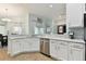 Modern white kitchen with stainless steel appliances and granite countertops at 6843 Boulder Run Loop, Wesley Chapel, FL 33545