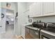 Laundry room with washer, dryer, and cabinets at 6843 Boulder Run Loop, Wesley Chapel, FL 33545