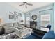 Relaxing living room with light blue walls, comfy seating, and fireplace at 6843 Boulder Run Loop, Wesley Chapel, FL 33545