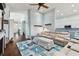 Spacious living room with light walls, comfortable seating, and a stylish area rug at 6843 Boulder Run Loop, Wesley Chapel, FL 33545