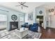Living room features light blue walls, hardwood floors, and arcade game at 6843 Boulder Run Loop, Wesley Chapel, FL 33545