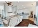 Open concept living room and kitchen with hardwood floors and light color scheme at 6843 Boulder Run Loop, Wesley Chapel, FL 33545