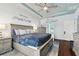 King-size bed in spacious main bedroom with plenty of natural light and calming decor at 6843 Boulder Run Loop, Wesley Chapel, FL 33545