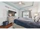 Spacious main bedroom with large TV and dresser, featuring wood floors and calming decor at 6843 Boulder Run Loop, Wesley Chapel, FL 33545