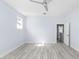 Empty bedroom with light gray walls, ceiling fan, and vinyl plank flooring at 8119 N Dakota, Tampa, FL 33604