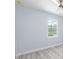 Spacious bedroom with light gray walls, ceiling fan, and vinyl plank flooring at 8119 N Dakota, Tampa, FL 33604