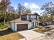 Two-story house with brown roof, white walls, and a brown door at 8119 N Dakota, Tampa, FL 33604