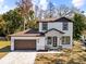 Two-story house with brown roof, white walls, and a brown door at 8119 N Dakota, Tampa, FL 33604