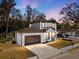 Two-story house with brown roof, white walls, and a brown door, at dusk at 8119 N Dakota, Tampa, FL 33604