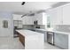 Modern kitchen with white and blue cabinets and a large marble island at 8119 N Dakota, Tampa, FL 33604