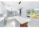 Bright kitchen features a large island with white quartz countertops and gray cabinets at 8119 N Dakota, Tampa, FL 33604