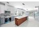 Modern kitchen with island, stainless steel appliances, and white shaker cabinets at 8119 N Dakota, Tampa, FL 33604