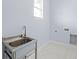 Laundry room with stainless steel utility sink and vinyl flooring at 8119 N Dakota, Tampa, FL 33604