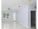 Living room with light gray walls, white marble floors, and a door at 8119 N Dakota, Tampa, FL 33604