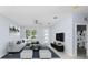 Living room with sectional sofa, a TV and built-in shelving at 8119 N Dakota, Tampa, FL 33604
