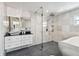 Modern bathroom with soaking tub, walk-in shower, and floating vanity at 221 Howard Dr, Belleair Beach, FL 33786