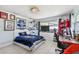 Spacious bedroom with a gaming setup and hockey decor at 221 Howard Dr, Belleair Beach, FL 33786